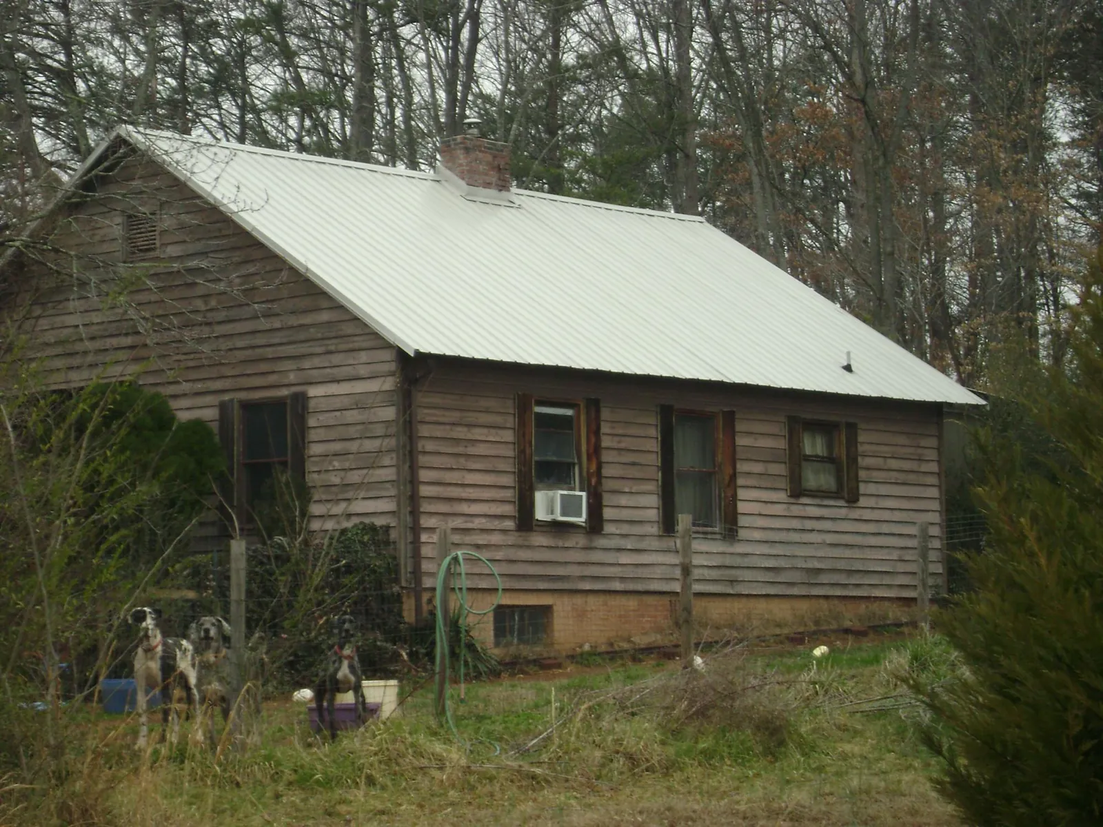 White metal roof on an old wood sided farmhouse, from a Metal Roof Installation job in Excelsior